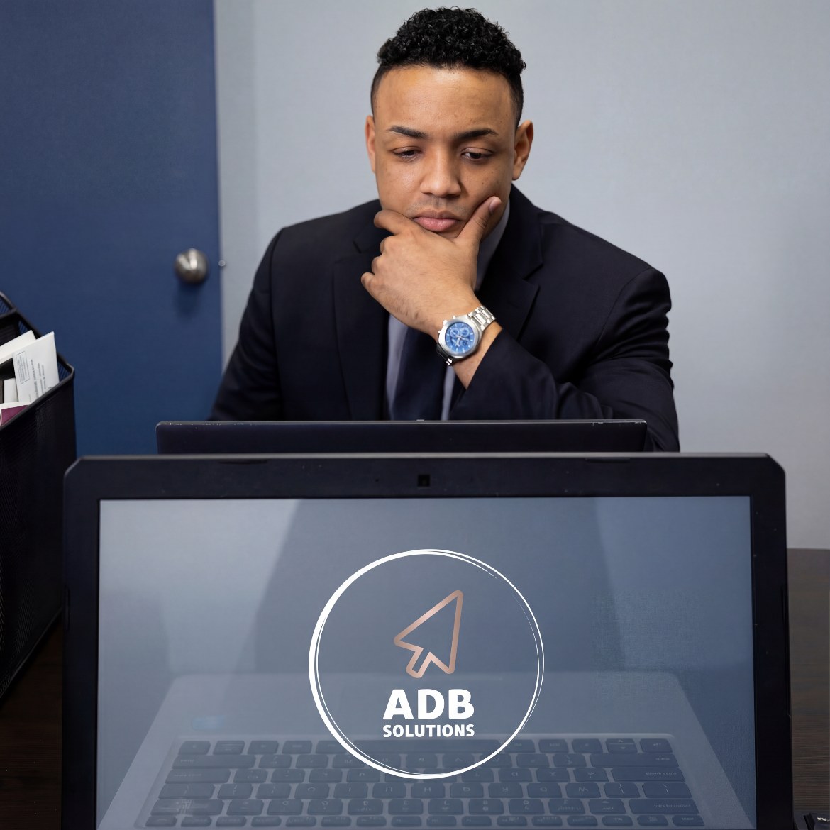 Austin Bryant, Owner and CEO of ADB Solutions, working at his desk